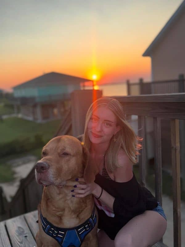 Contact Us Jennifer with big tan dog at sunset